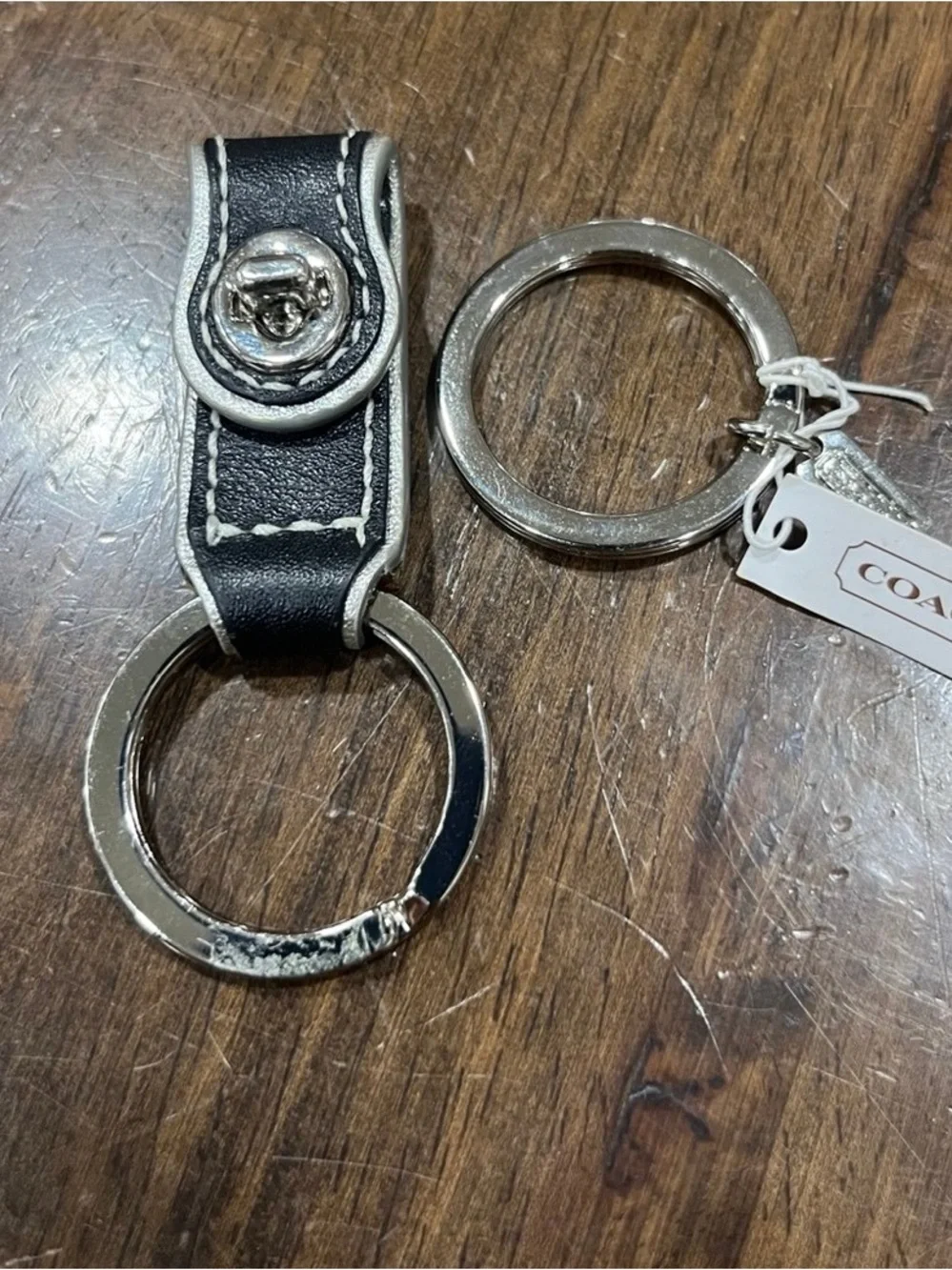 Coach black leather valet keychain.